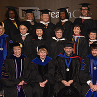 graduates of a Master's program sitting together for a photo